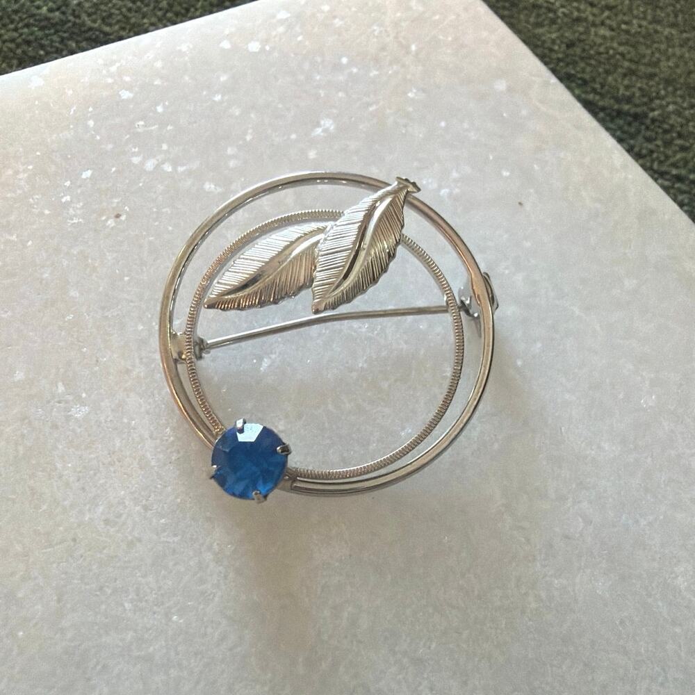 Silver tone and blue stone circle leaf brooch